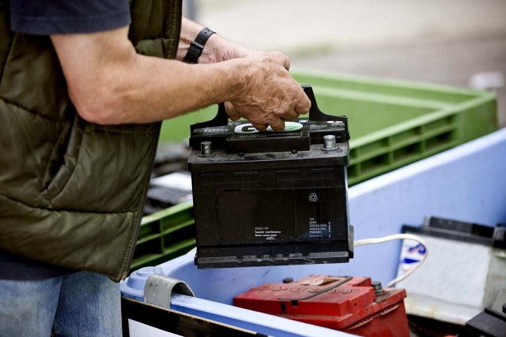 Old car battery being taken away for recycling by Boonah Batteries